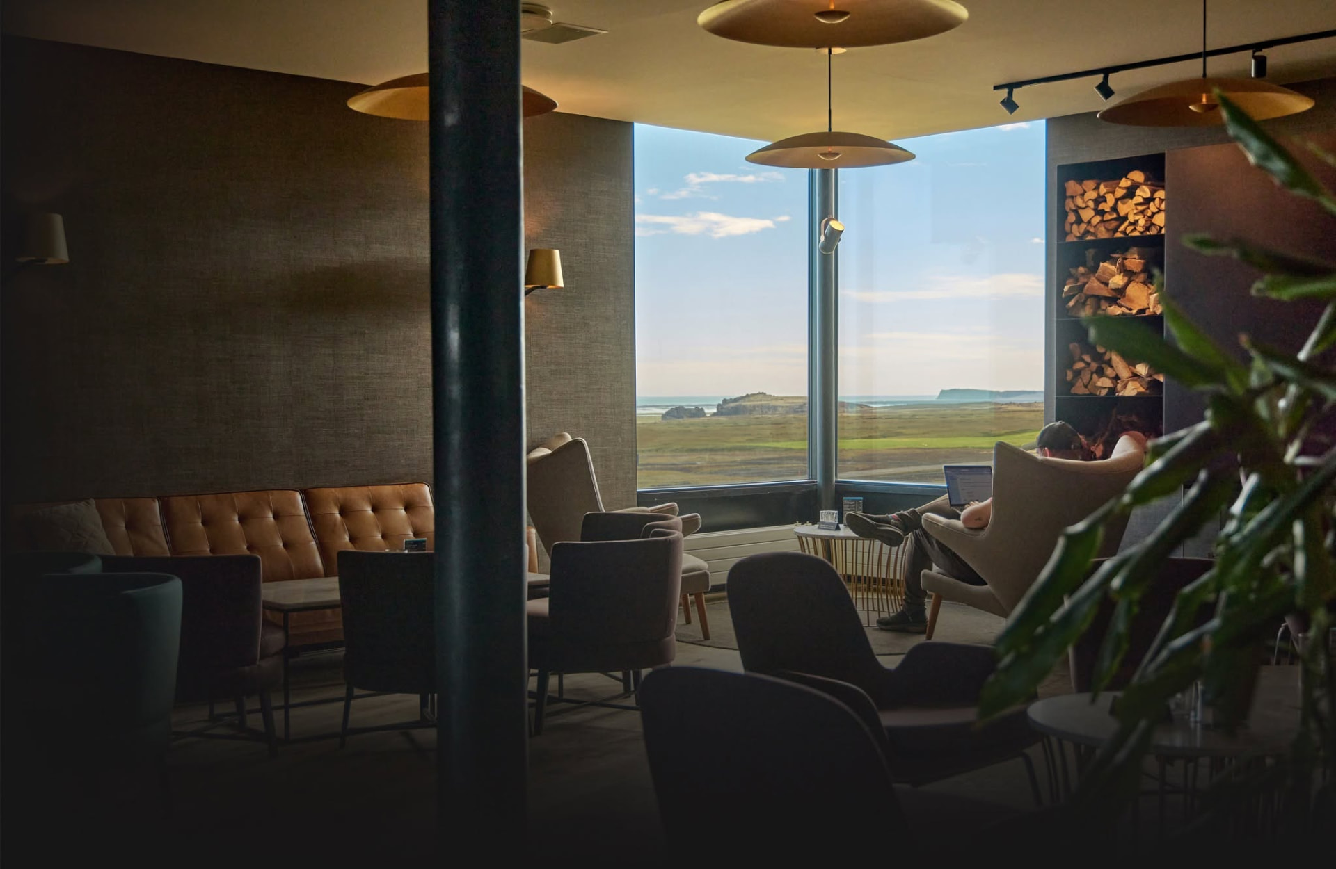 Lounge at Fosshotel Glacier Lagoon with floor-to-ceiling windows toward the coastal plain and ocean