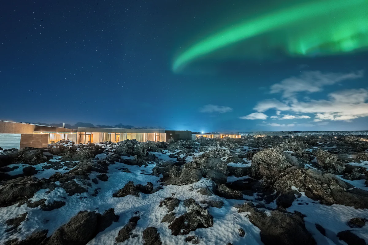 Northern lights above Silica Hotel and the snow-covered lava landscape in Iceland