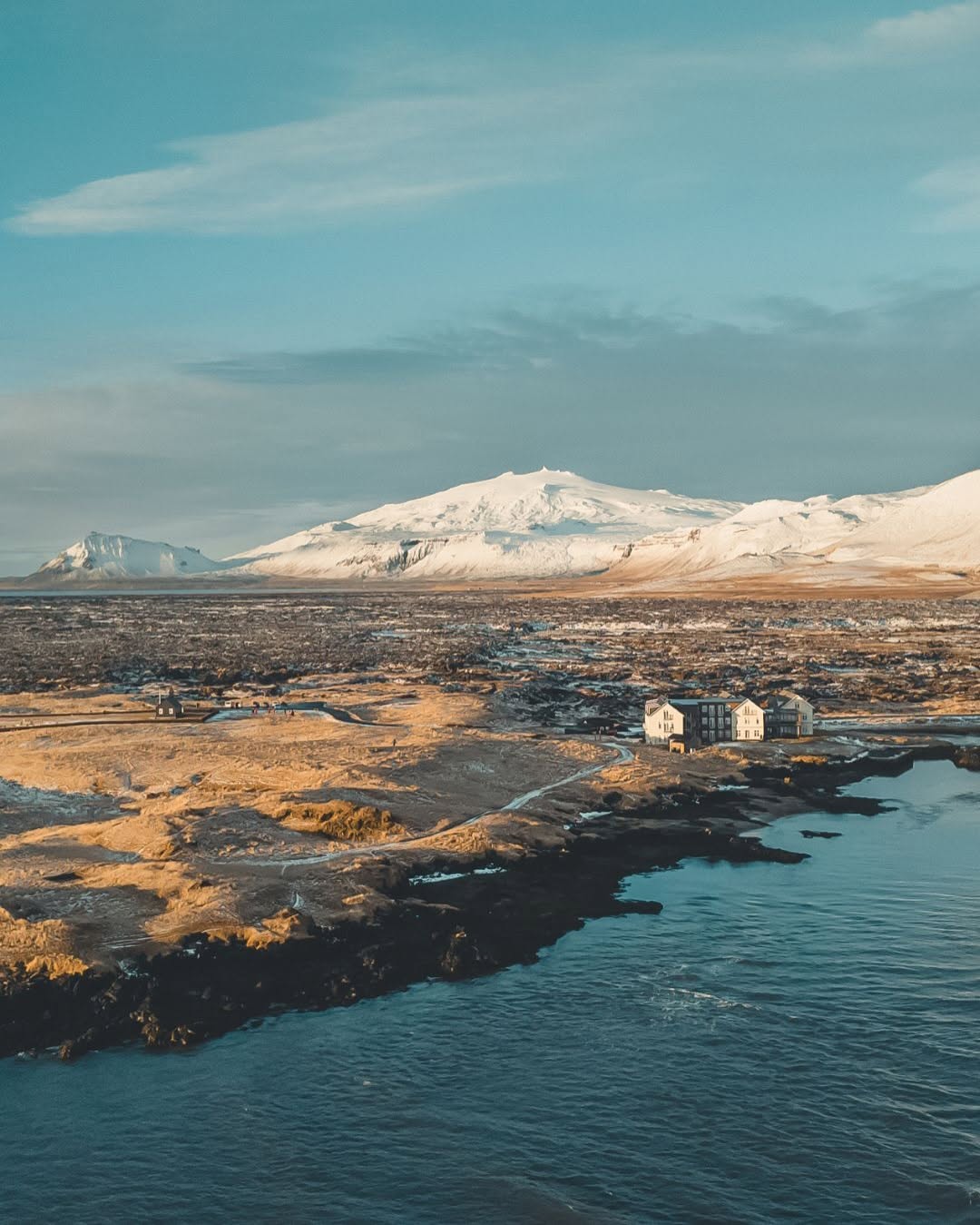 Hótel Búðir on the grassy lava fields of Snæfellsnes with Snæfellsjökull in the distance