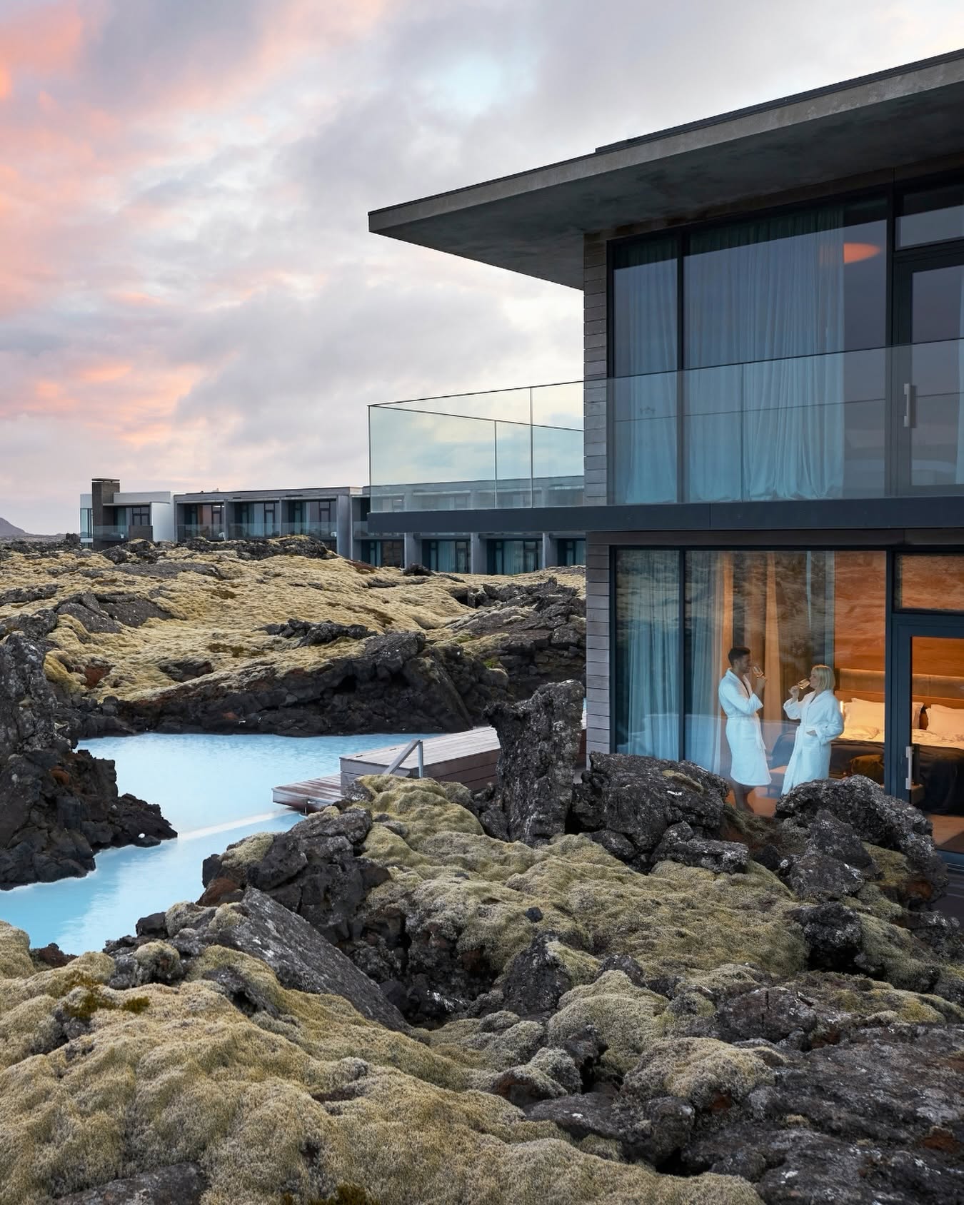 The Retreat at Blue Lagoon beside milky-blue geothermal water and moss-covered lava rocks