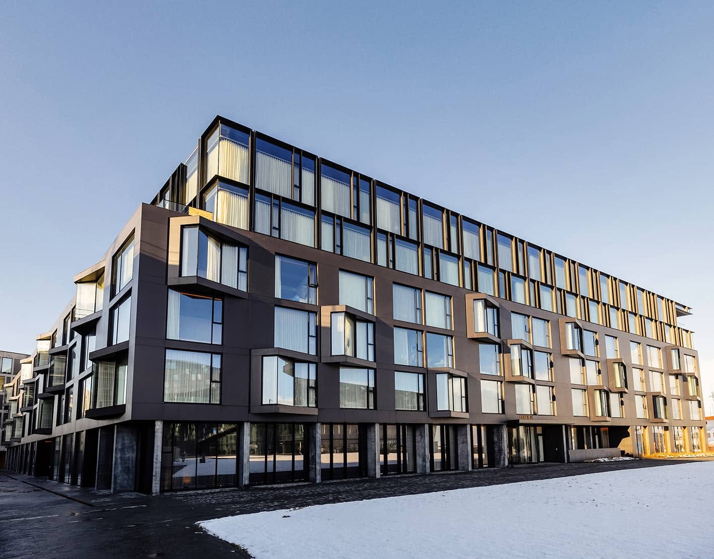 Exterior of The Reykjavik EDITION with dark cladding and angular bay windows